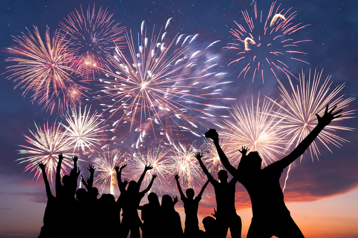 people standing in front of fireworks