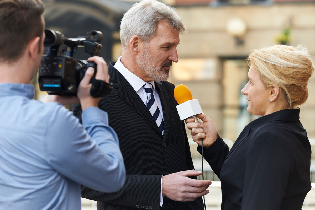 business man giving a new interview on camera