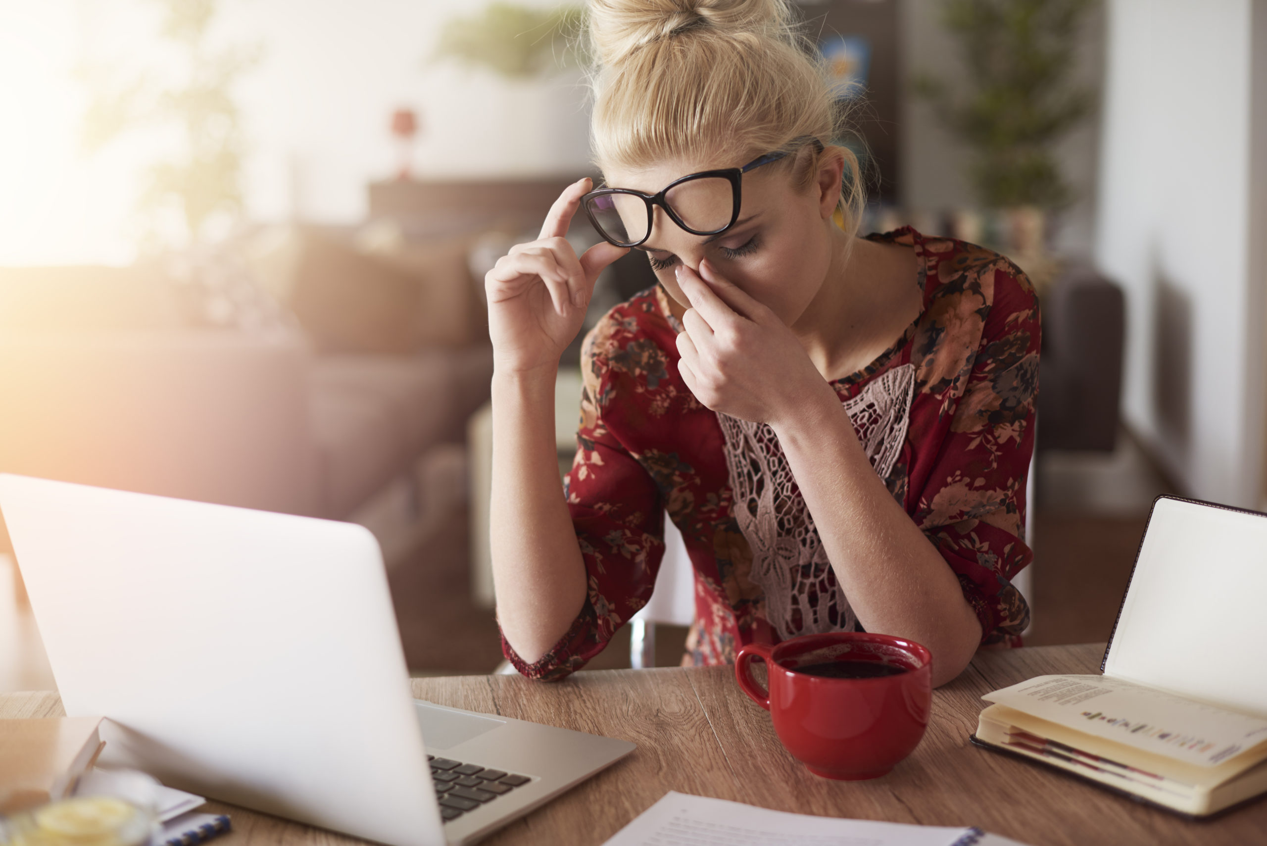 image of woman with a headache due to work frustration