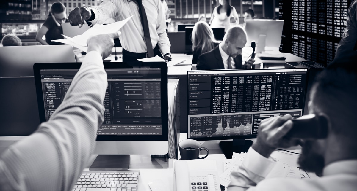 stock brokers looking at the computers
